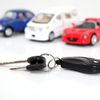 Image with 3 toy cars and a set of keys.