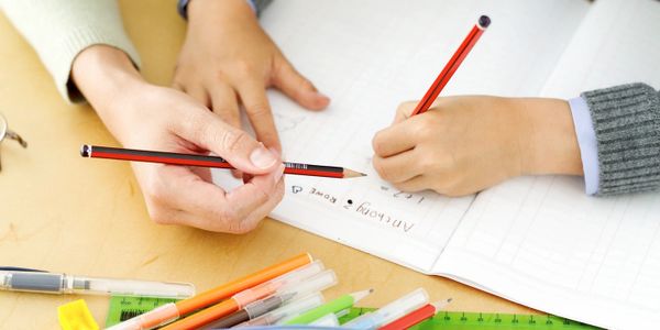 A teacher helping her student with math