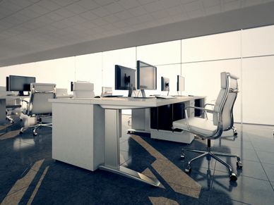 Modern office space with white desks and ergonomic chairs.