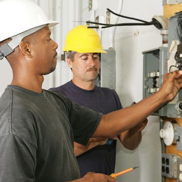 Home inspectors inspecting electrical box