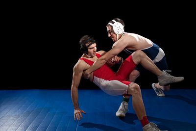 A wrestler throwing his opponent to the ground