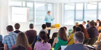People attending a presentation in a conference room.