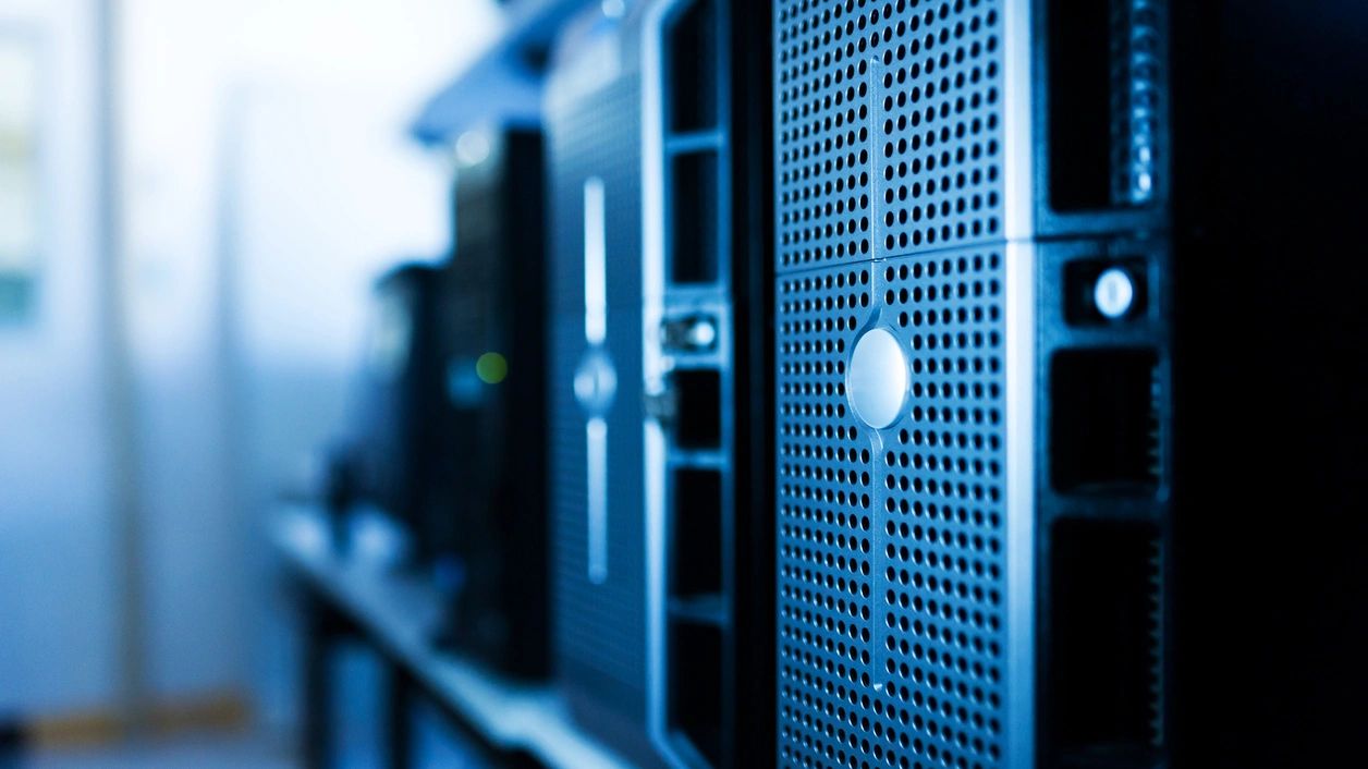 Close-up of server racks in a data center with blue lighting.