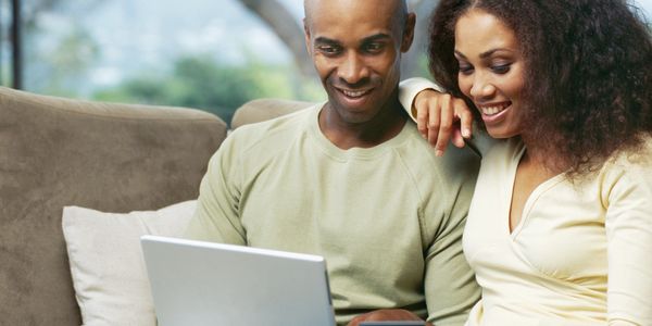 A couple happily browsing the internet.