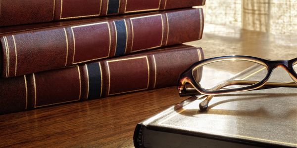 Law Books with glasses resting on top