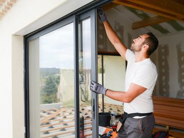 man installing sliding door