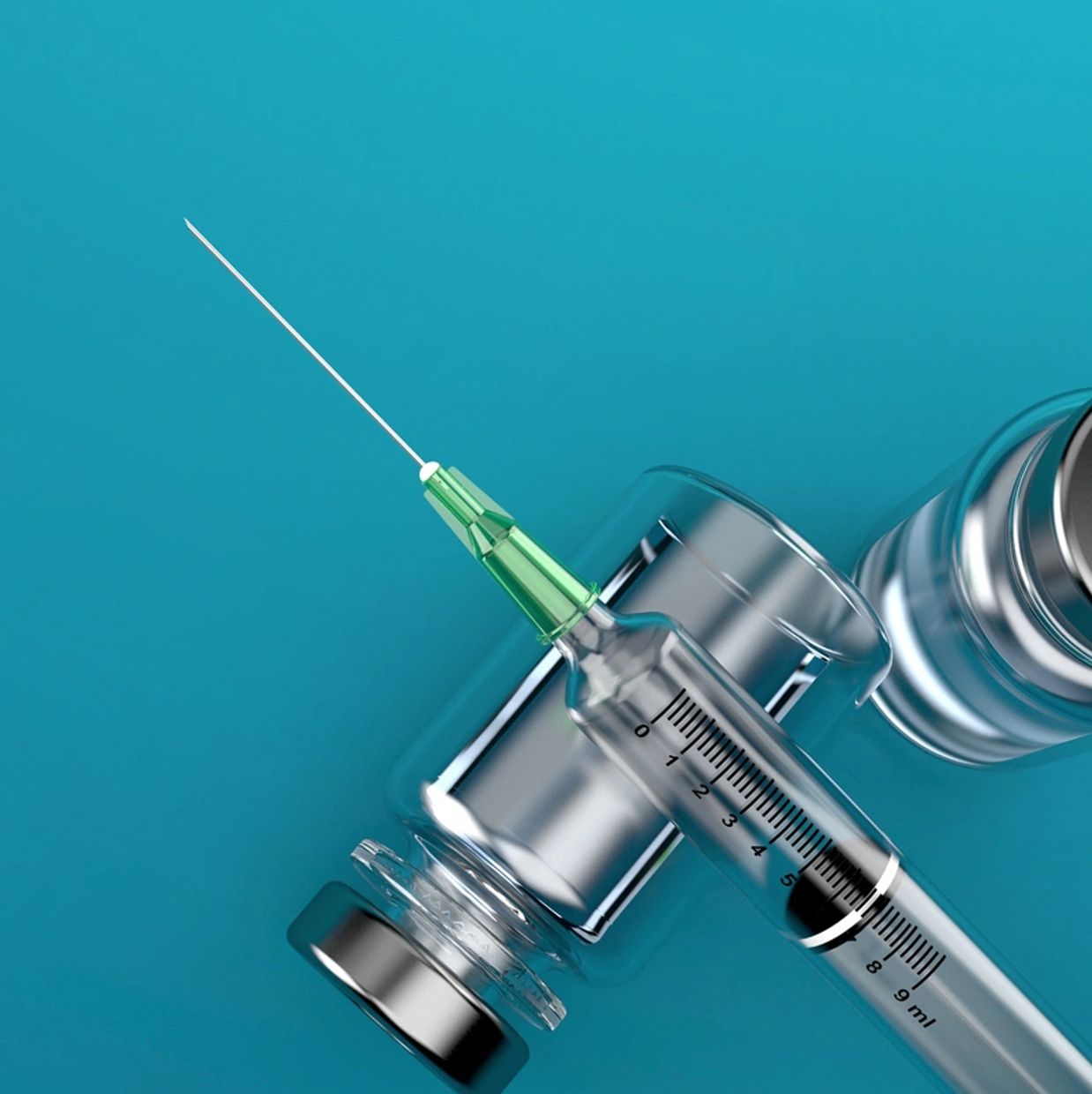Syringe with a needle and vaccine vials on a blue background.