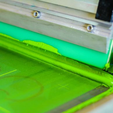 Green ink on the automatic screen press. 