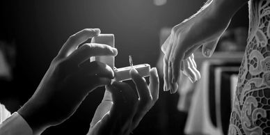 Hands preparing a cigarette in black and white.