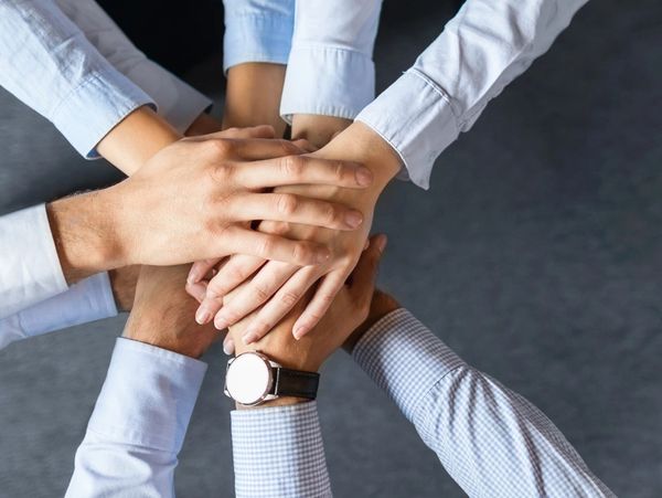 Two people holding hands in a circle.