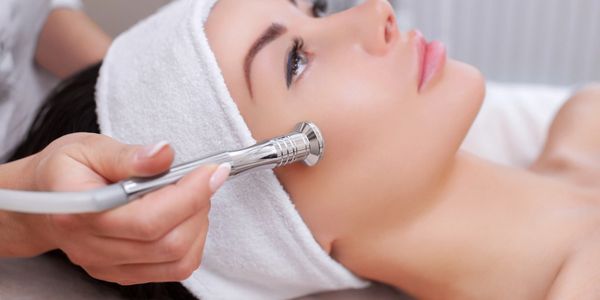 Women receiving laser treatment for her face. 