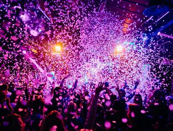 A lively party scene with confetti and colorful lights.
