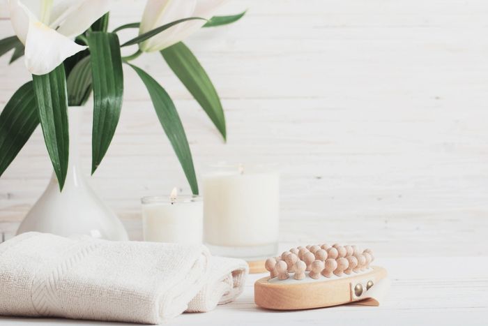 Relaxing spa candles and towels with plants