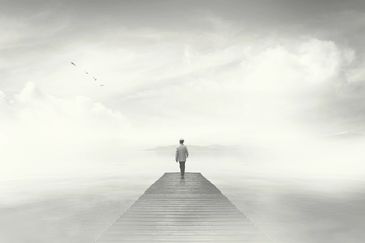 person on a  pier looking out to sea