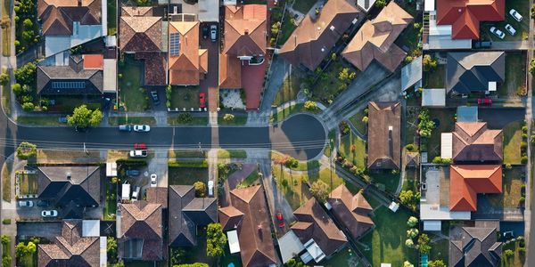 Aerial view of a suburban neighborhood with houses around a cul-de-sac.