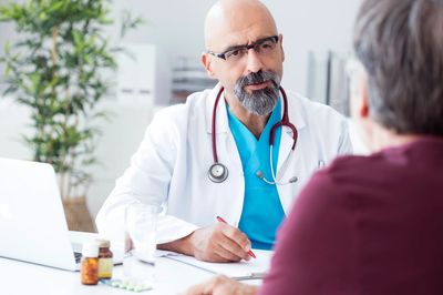 Doctor consulting a patient in an office.