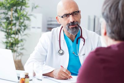 Doctor consulting with a patient in a medical office.