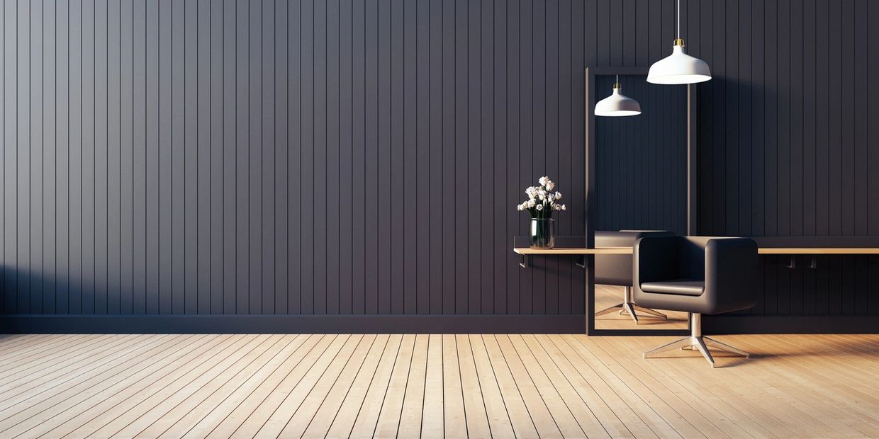Minimalist interior with black wall and large mirror.