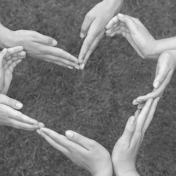 Multiple hands forming a heart