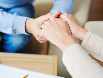 A two women hold hand with each other