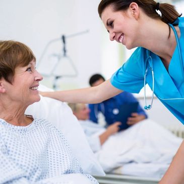 Registered nurse assisting an elderly patient in a care home provided by Unicorn Healthcare Agency.