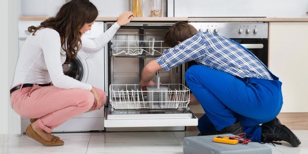 Technician repairing a dishwasher