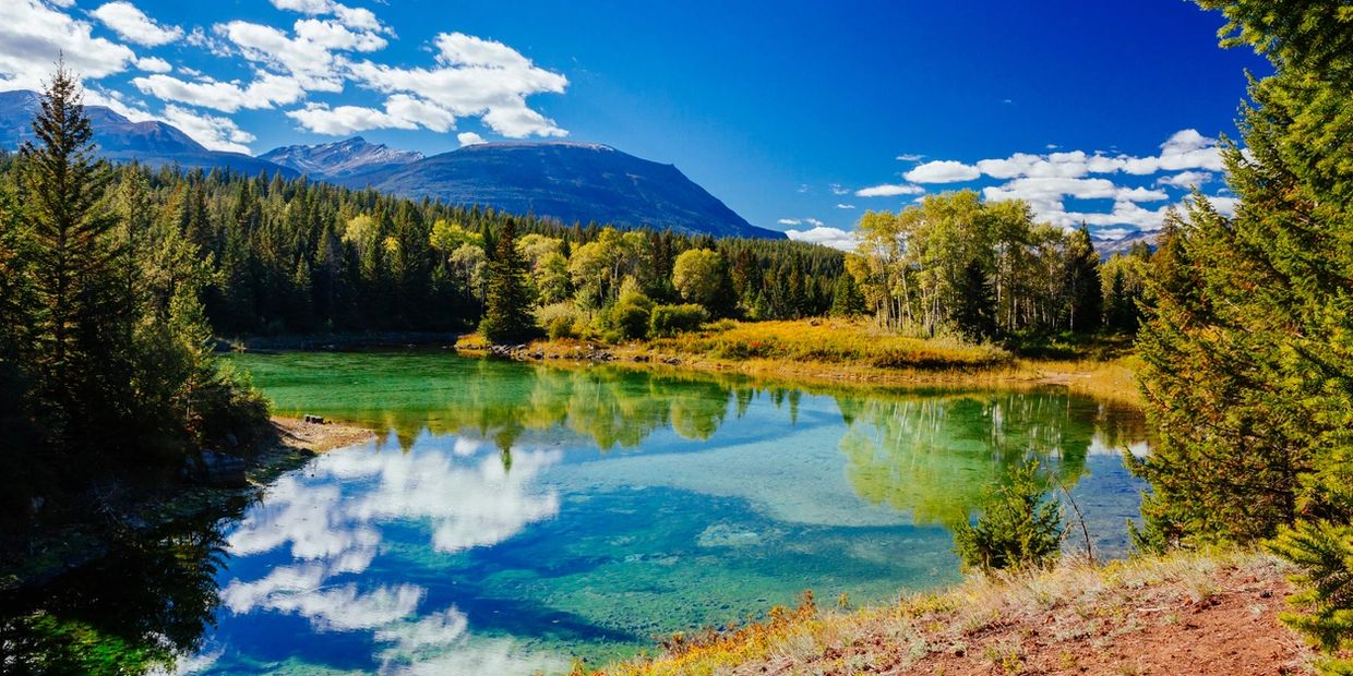 Alaska lake reflecting blue sky and clouds