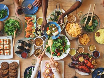 people sitting at a table together eating a seafood dinner