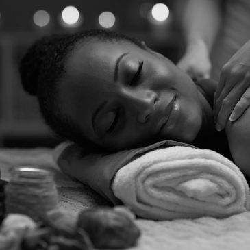 Woman enjoying a relaxing massage with a peaceful smile.