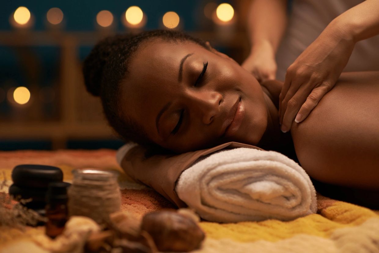Woman enjoying a relaxing shoulder massage in a spa setting.