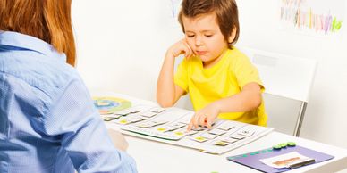 little boy learning how to count with teacher
