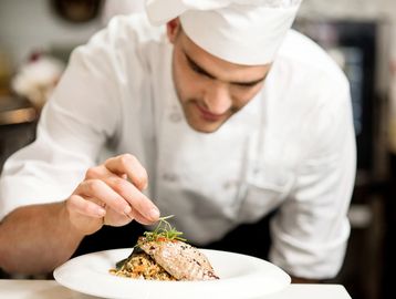 chef adding finishing touches to a dish