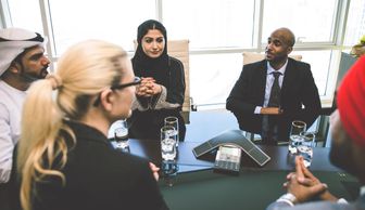 people talking while sitting around a table