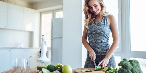 Cutting up healthy food to meal prep and achieve fitness goals.