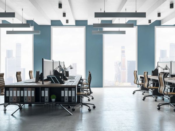 Modern office space with large windows and ergonomic chairs.