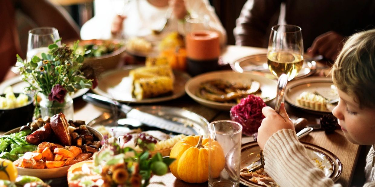 Family enjoying a festive meal together with colorful dishes and decorations.