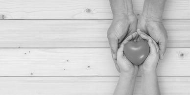 Hands sharing apple