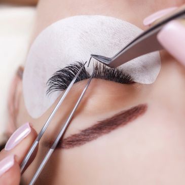  A person having a lash extension service on eyebrows