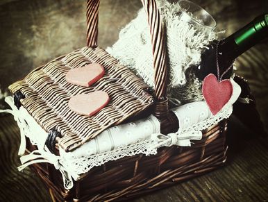 a romantic wicker gift basket with love hearts and champagne