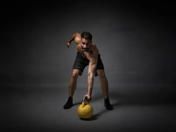 A Man Lifting a Kettlebell