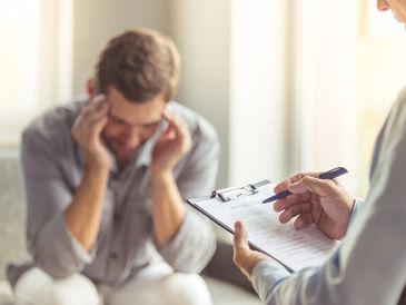 Man stressed during therapy session.