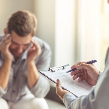 Therapist taking notes as patient describes trauma