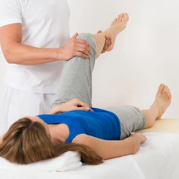 Sport massage, stretching leg muscle lying on massage table