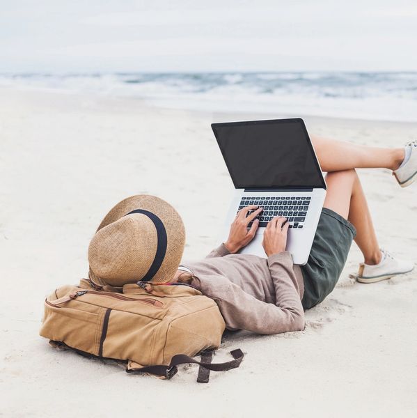 person on beach with tablet