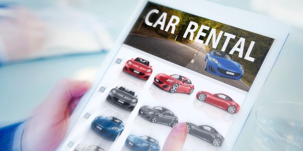 Person browsing car rental options on a digital tablet showing various car models.
