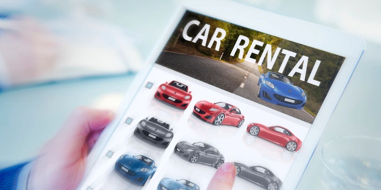Browsing car rental options on a tablet with various cars displayed.
