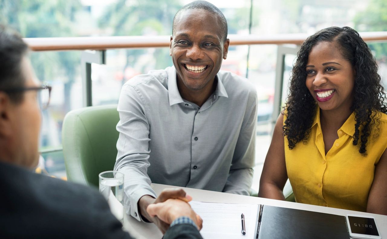 Couple meets with a real estate professional to help guide them on their journey of buying a home.