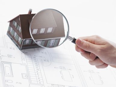 A house with a magnifying glass above it