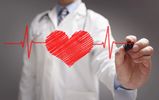 Doctor drawing a red heart with heartbeat lines on transparent screen.