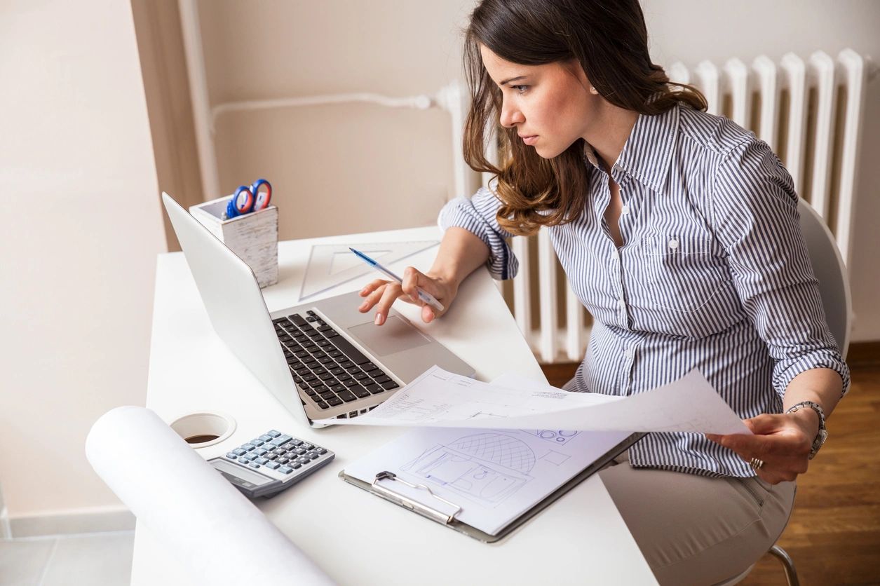 A lady reviews her work and looks at where to implement changes and improvements.